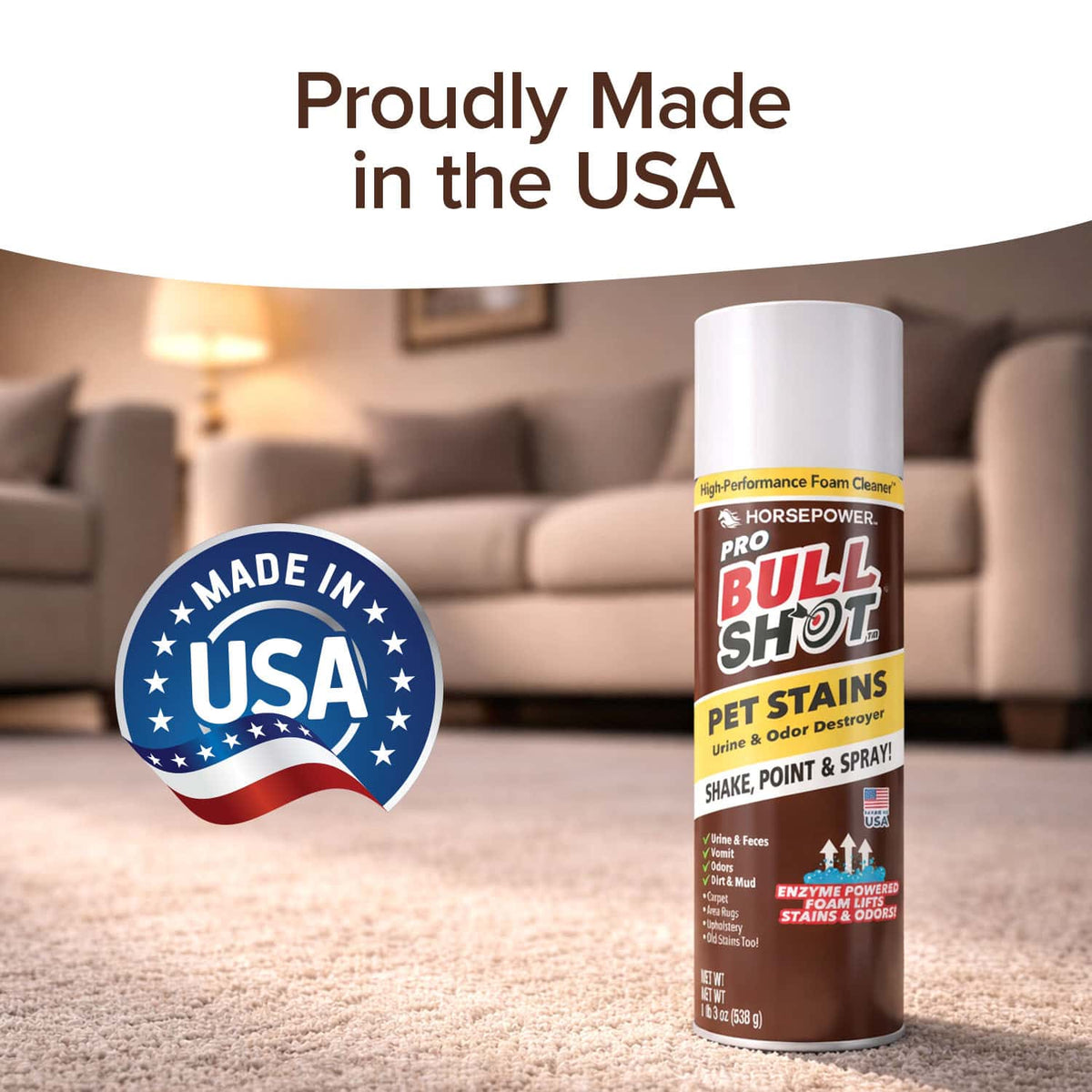 A can of Bull Shot Pet Stains foaming spot cleaner sits on a carpet, with a Made in USA badge and “Proudly Made in the USA” above. A blurred living room background highlights this pet-safe carpet stain remover.