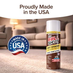 A can of Bull Shot Pet Stains foaming spot cleaner sits on a carpet, with a Made in USA badge and “Proudly Made in the USA” above. A blurred living room background highlights this pet-safe carpet stain remover.